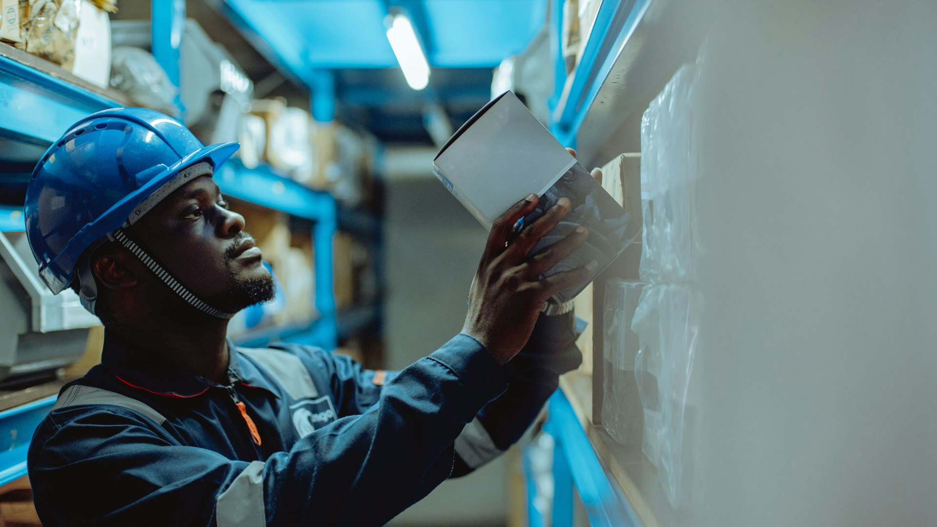 a man in a hard hat is looking at a piece of paper